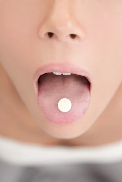 Woman taking pill or medicin — Stock Photo, Image