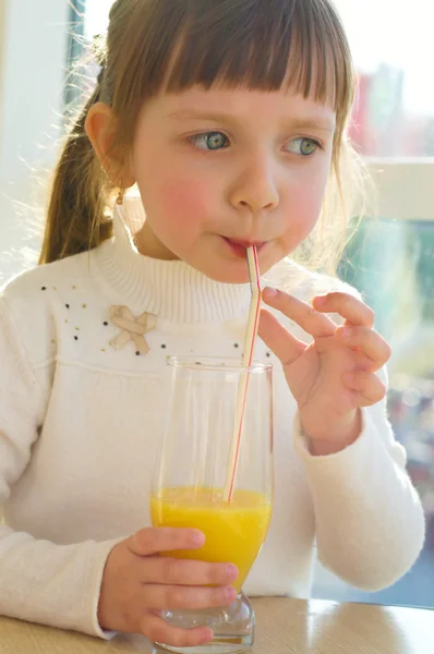 Portrait of little girl drinking juice Stock Photo