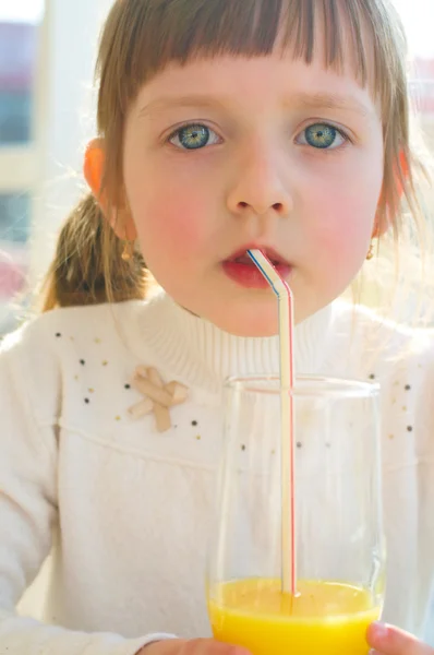 Маленькая девочка пьет сок — стоковое фото