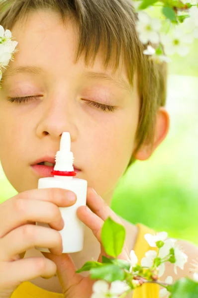 Boy spraying his nose — Stock Photo, Image