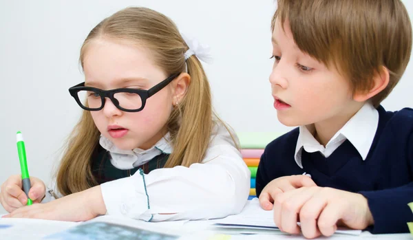 Schoolchildren writing at school Royalty Free Stock Images