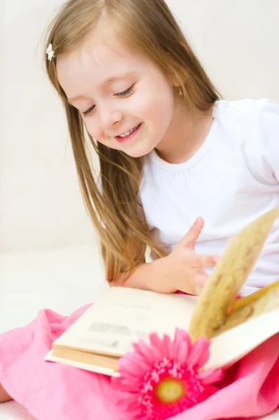 Criança brinca com livro — Fotografia de Stock