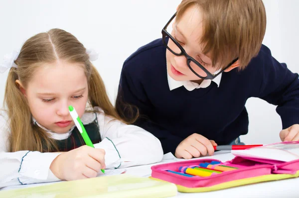 Schoolchildren writing in workbook Stock Photo