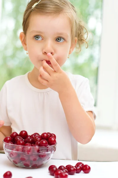 Kid with cherry berries Royalty Free Stock Images