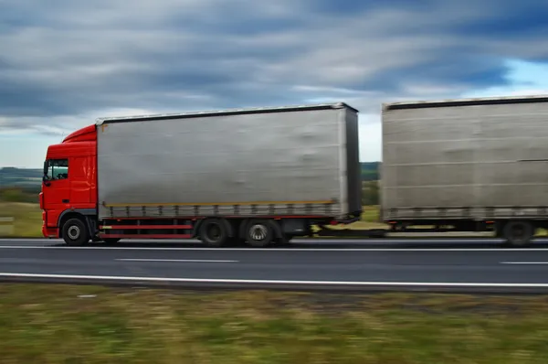 A truck with a trailer on the road in the countryside — Stock Photo, Image