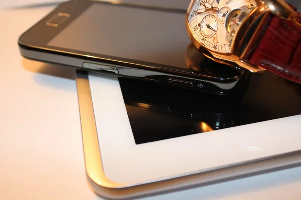 Golden wrist watch,smartphone and white tablet PC — Stock Photo, Image