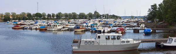 Many motor boats and small yachts near piers