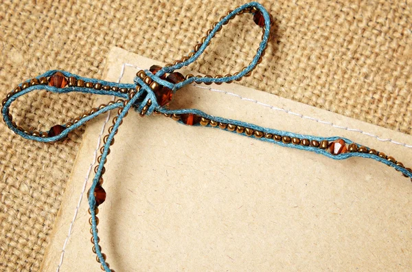 Beaded bow with card — Stock Photo, Image