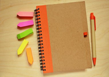 kapalı defter, kalem ve çıkartmalar