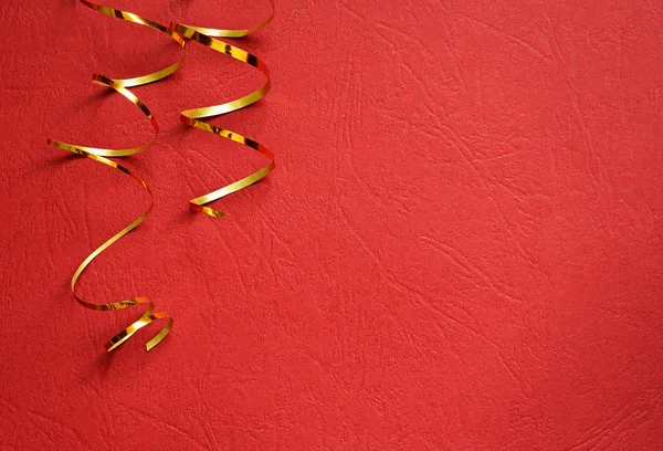 Red background with golden streamers — Stock Photo, Image