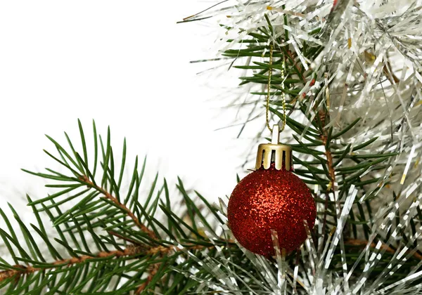 Christmas tree with red ball and tinsel — Stock Photo, Image