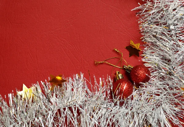 White tinsel and balls on red background — Stock Photo, Image