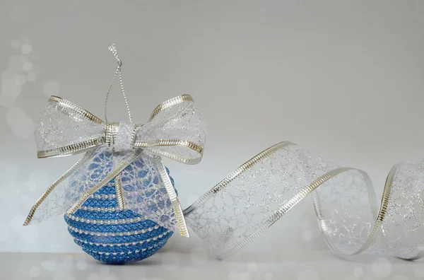 Blue christmass ball and glitter ribbon — Stock Photo, Image