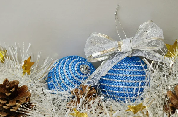 Blue christmass balls, tinsel and pinecones — Stock Photo, Image