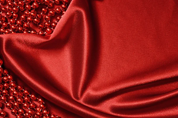 Red satin drapery and beads — Stock Photo, Image