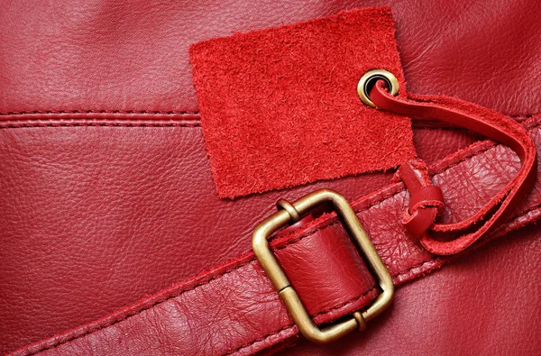 Red leather and a label — Stock Photo, Image
