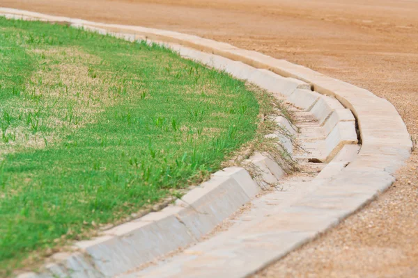 Ditch between green football ( soccer ) field and racetrack — Stock Photo, Image