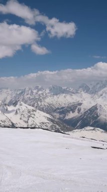 Dikey video. Elbrus Dağı 'ndan Kafkasya Dağları' nın karla kaplı sırtına bak..