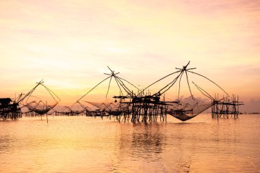Gölün güneydoğu Asya, Tayland 'da sabah ışığında Asya tarzı balık avlama aracı silueti..