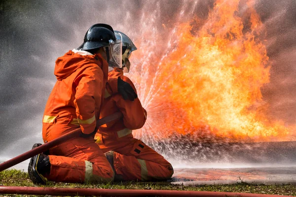 Firefighter Spraying Water Extinguish Fire Training Center — Stock Photo, Image