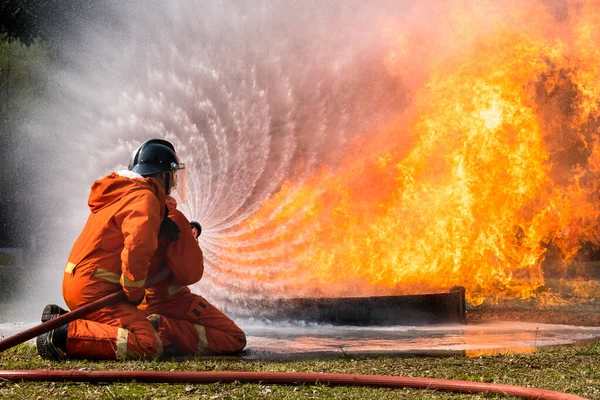 Firefighter Spraying Water Extinguish Fire Training Center — Stock Photo, Image