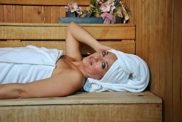 Woman relaxing in a sauna — Stock Photo, Image