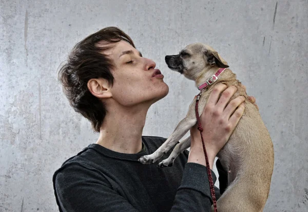 Jovem com o seu cão nos braços — Fotografia de Stock