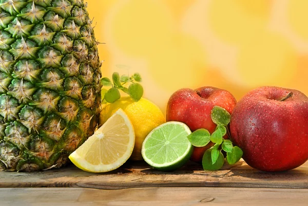 Pineapple, red apples, lemons — Stock Photo, Image