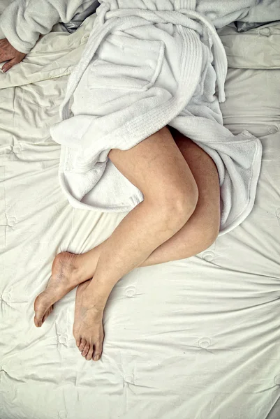 Legs on a bed — Stock Photo, Image