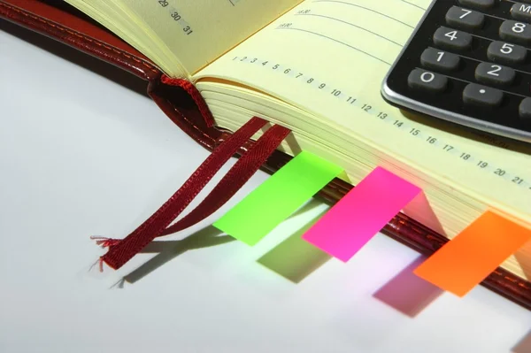 Notebook with calculator and stickers — Stock Photo, Image