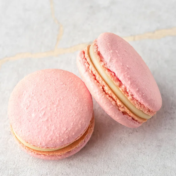 Sweet Strawberries macarons on a stone background. Traditional French dessert — Foto Stock