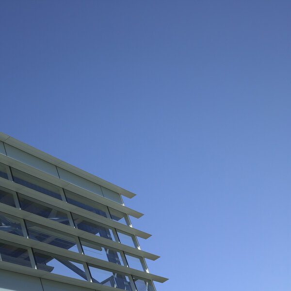 Modern glass and metal building with blue sky
