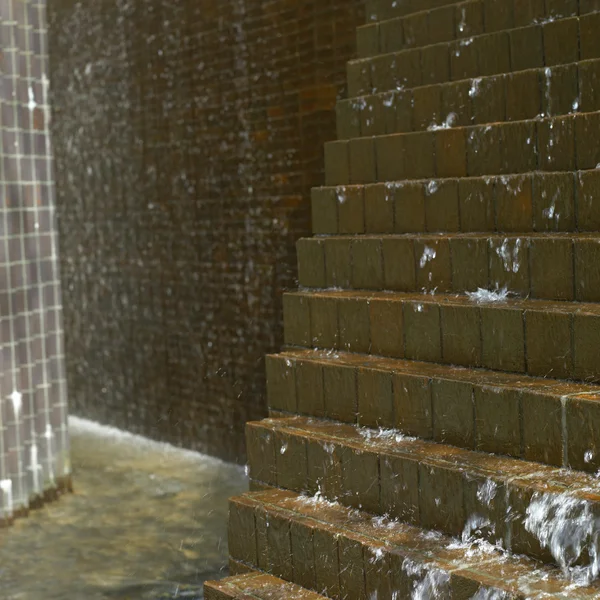 Water cascading down on bricks — Stock Photo, Image
