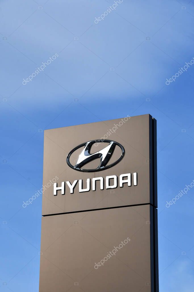 Pontypridd, Wales - February 2022: Sign outside a Hyundai car showroom isolated against a blue sky. No people.
