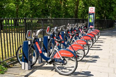 Londra, İngiltere - Ağustos 2021: Kiralama planının bir parçası olarak bir otoparkta bisiklet kuyruğu. Bisikletlerin sponsoru Santander Bank.