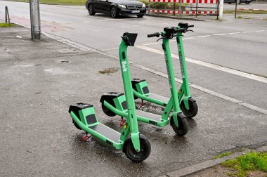 Mannheim, Germany - April 2022: Electric scooters parked on a street near the city centre. The scooter is part of a rental sharing system.