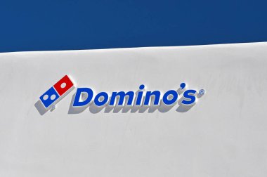Mykonos, Yunanistan - Haziran 2022: Domino 's pizza mağazasının dış cephesini imzalayın. Bina geleneksel badana ile kaplıdır..
