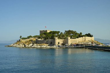 Kusadasi, Turkey - June May 2022: Byzantine Castle on Pigeon Island in the port of Kusadasi.