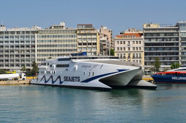 Athens, Greece - May 2022: Twin hull high speed ferry Champion Jet moored  in the port of Piraeus after arriving from one of the Greek Islands. The ferry is operated by Seajets.