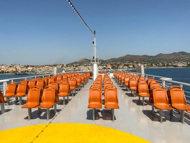 Aegina, Yunan Adaları, Yunanistan - Mayıs 2022: Atina 'ya giden Aegina' dan kalkan yolcu feribotunun üst güvertesindeki boş koltuklar.