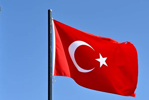 National flag of Turkey isolated against a deep blue sky. No people.