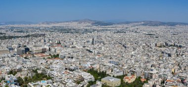 Athens, Greece - May 2022: Panoramic aerial view of homes and buildings in the city stretching into the distance.