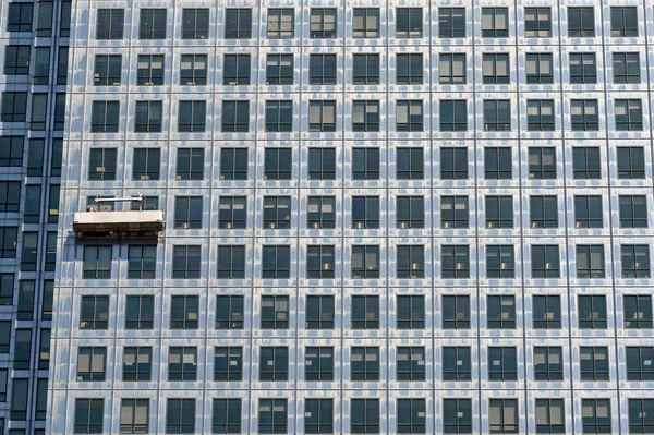 London, England - June 2022: Window cleaning cradle on the outside of an office tower block in anary Wharf