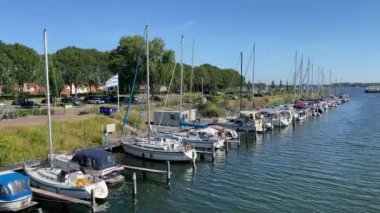 Veere, The Netherlands  August 2022: Row of motorboats and yachts moored on the canal in the small Dutch town of Veere