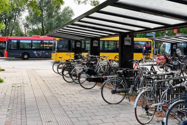 Edam, Netherlands - August 2022: Bicycles left in a bike rack at the town's bus station.