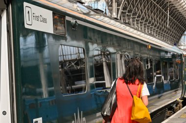London, England - 21 June 2022: Passenger walking past a first class carriage on a high speed train at pddington railway station