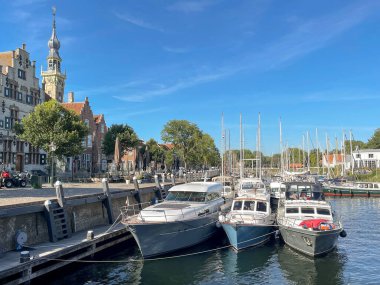 Veere, Netherlands - August 2022: Boats and yachts moored in the harbour in the town's harbour