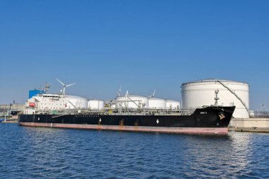 Antwerp, Belgium - August 2022: Large oil tanker moored in the city's commercial port. It is a major port for unloading oil for Europe.