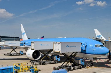 Amsterdam, Netherlands - August 2022: KLM Boeing 777 jet being loaded with catering supplies using a scissor lift truckat Schipol airport