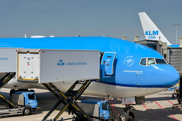 Amsterdam, Netherlands - August 2022: KLM Boeing 777 jet being loaded with catering supplies using a scissor lift truck at Schipol airport